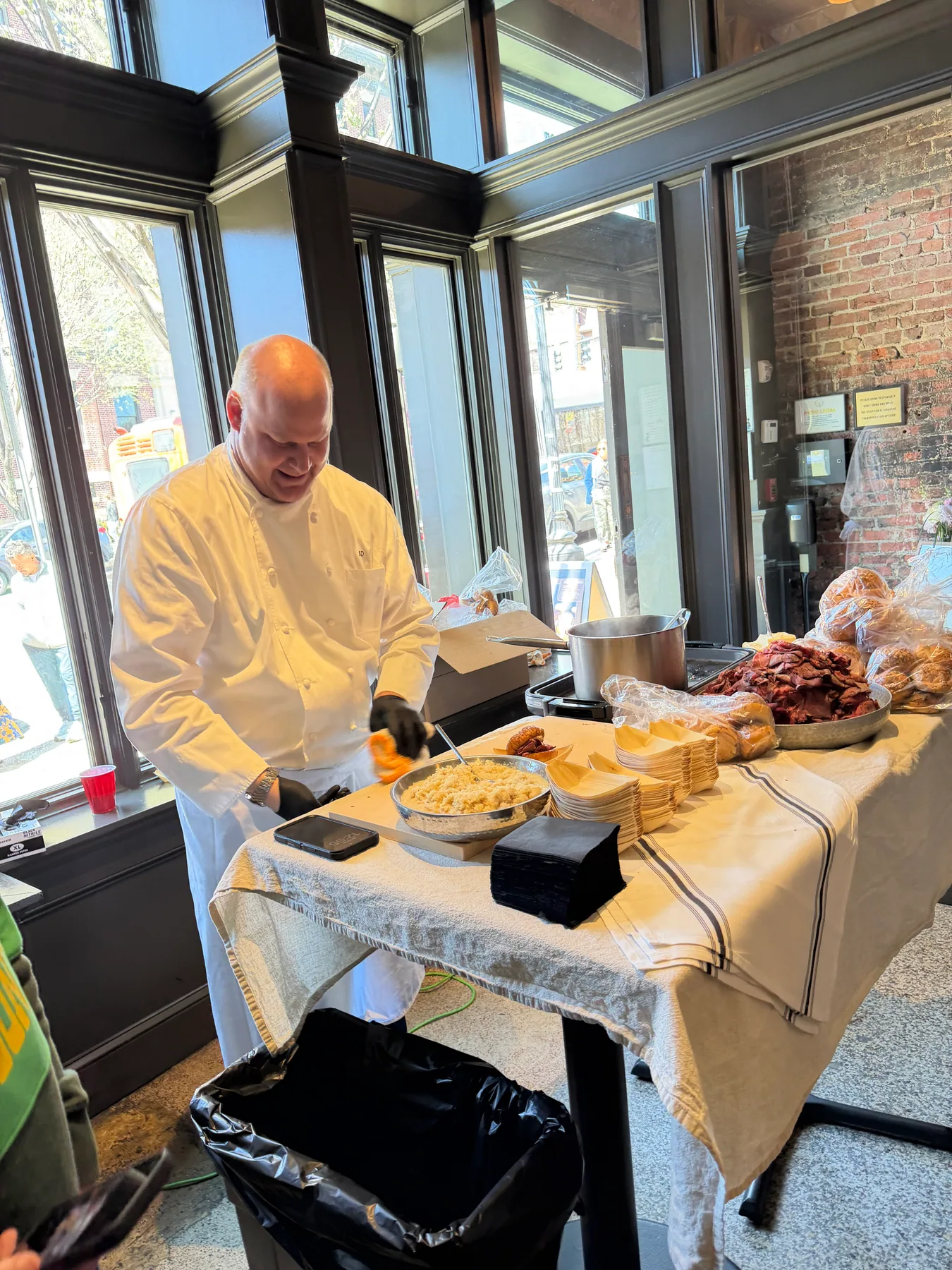 A chef presenting a table of dishes during an event