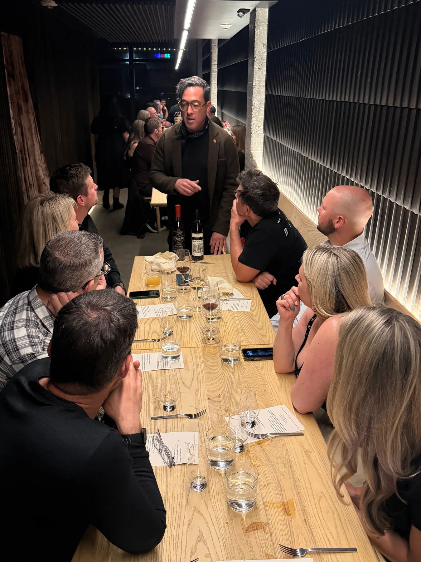 Guests listening to a speaker during an intimate tasting