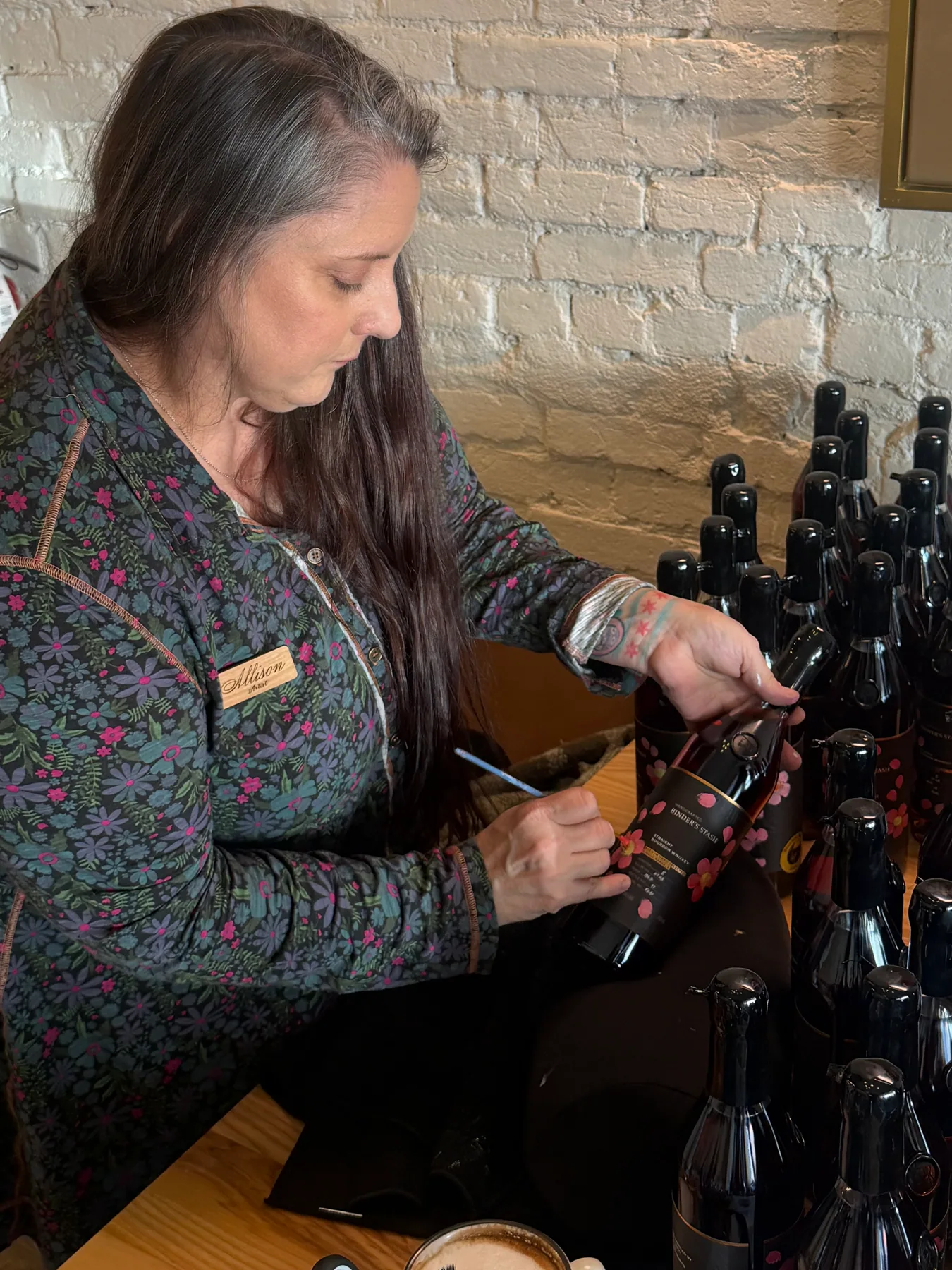 An event host opening a bottle at a tasting station