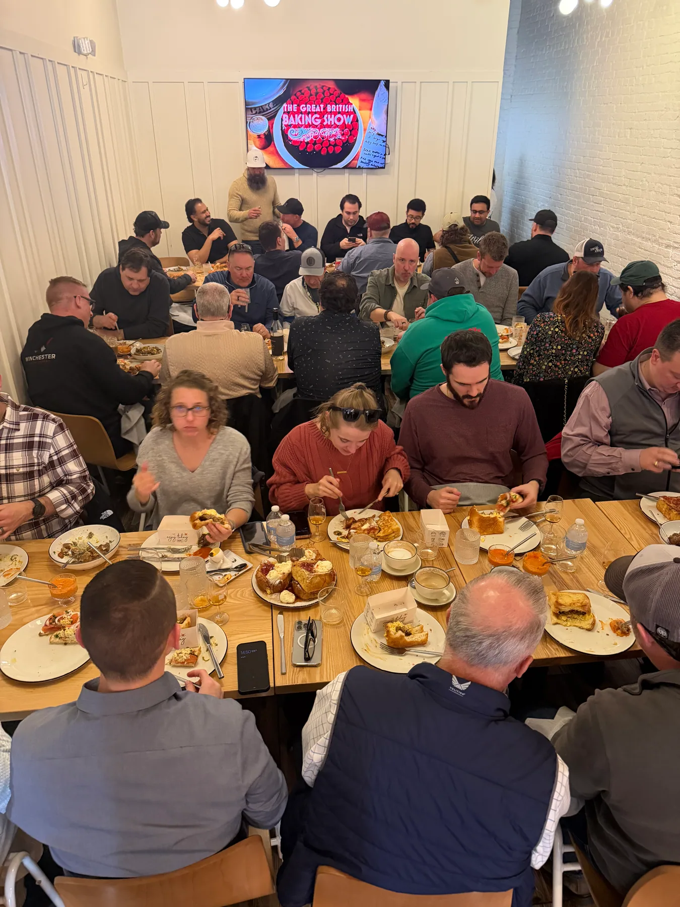 Guests sharing a meal at a long communal table