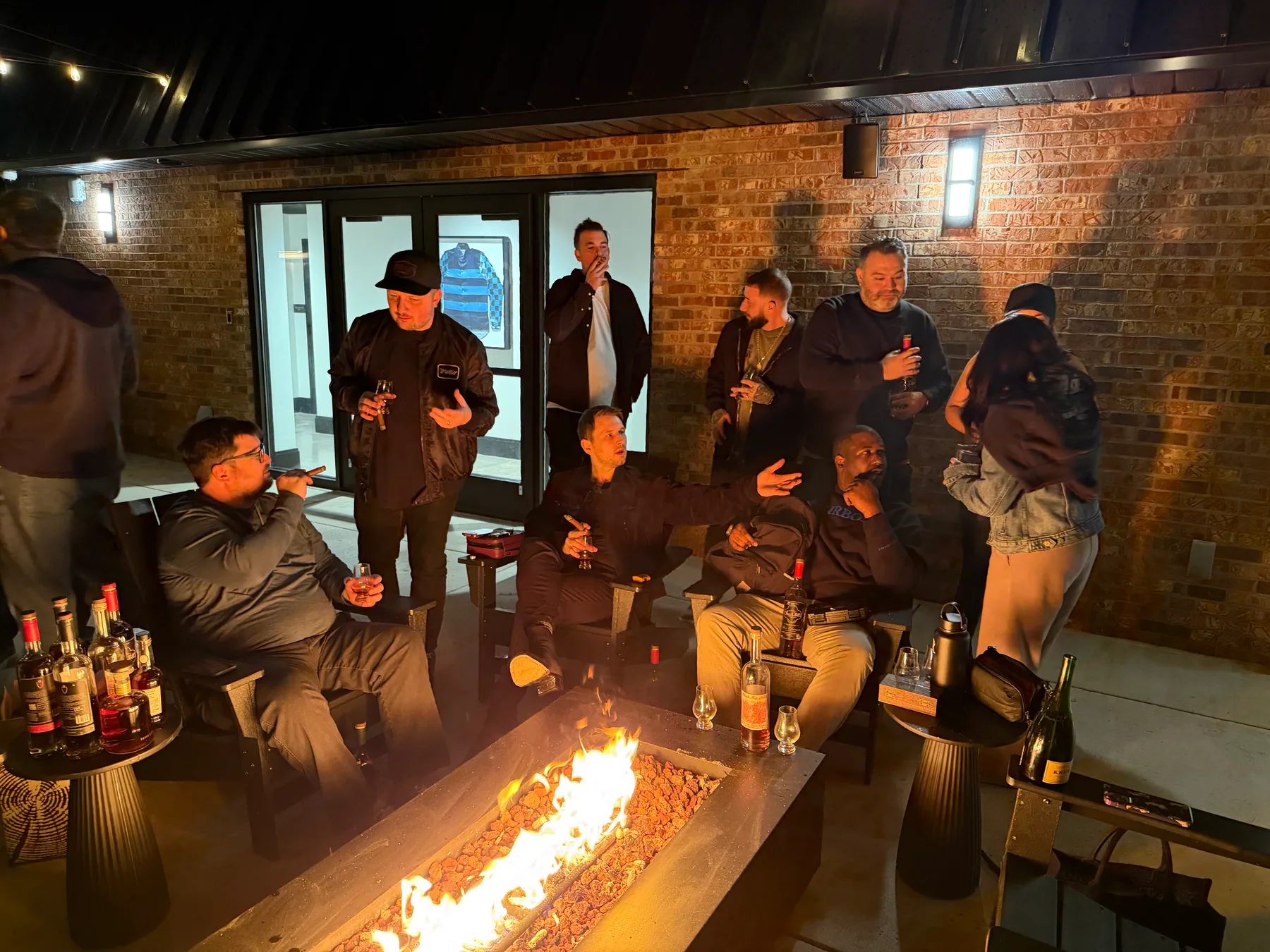 Guests socializing around a fire pit at an evening event