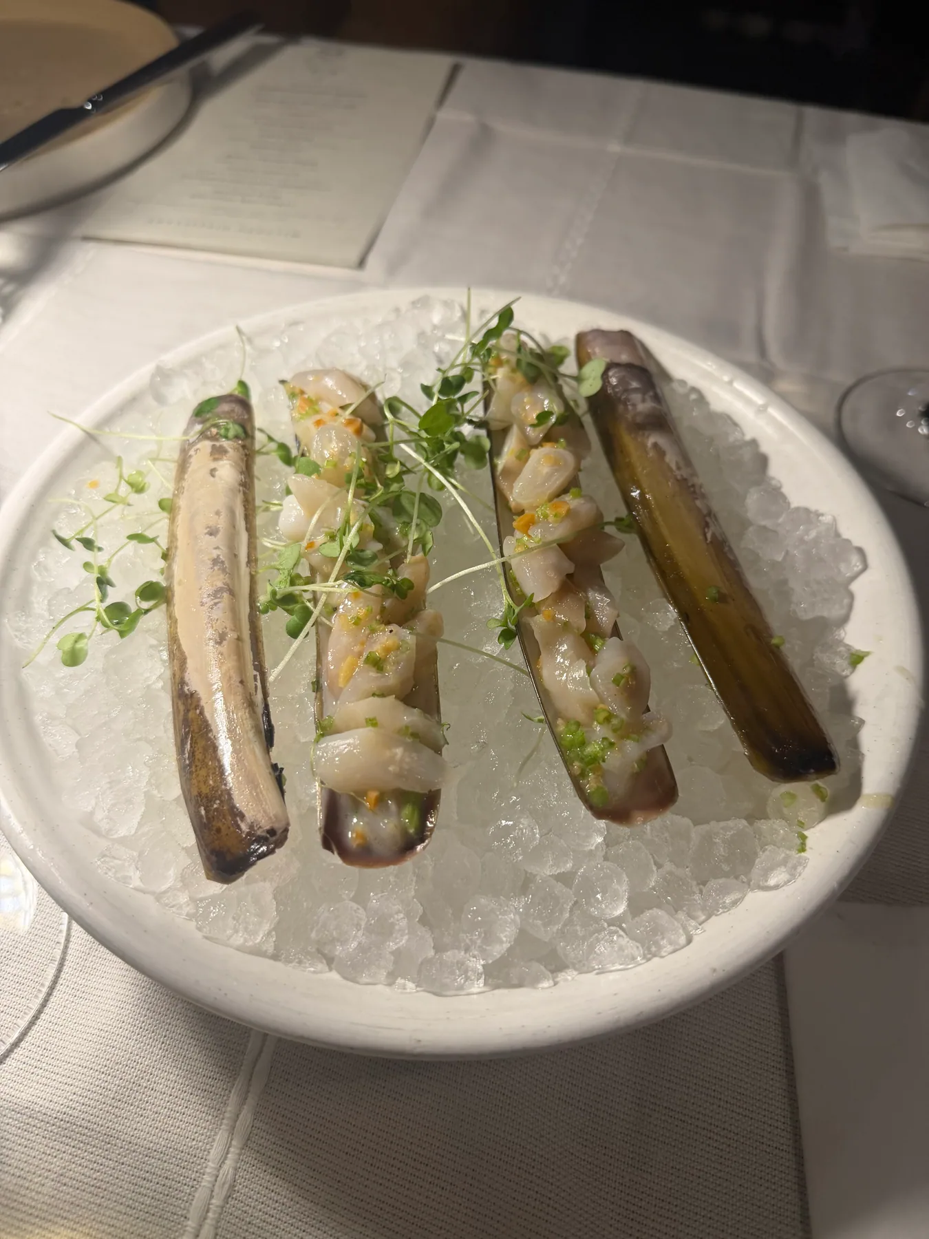 A plated seafood course served during a dinner event