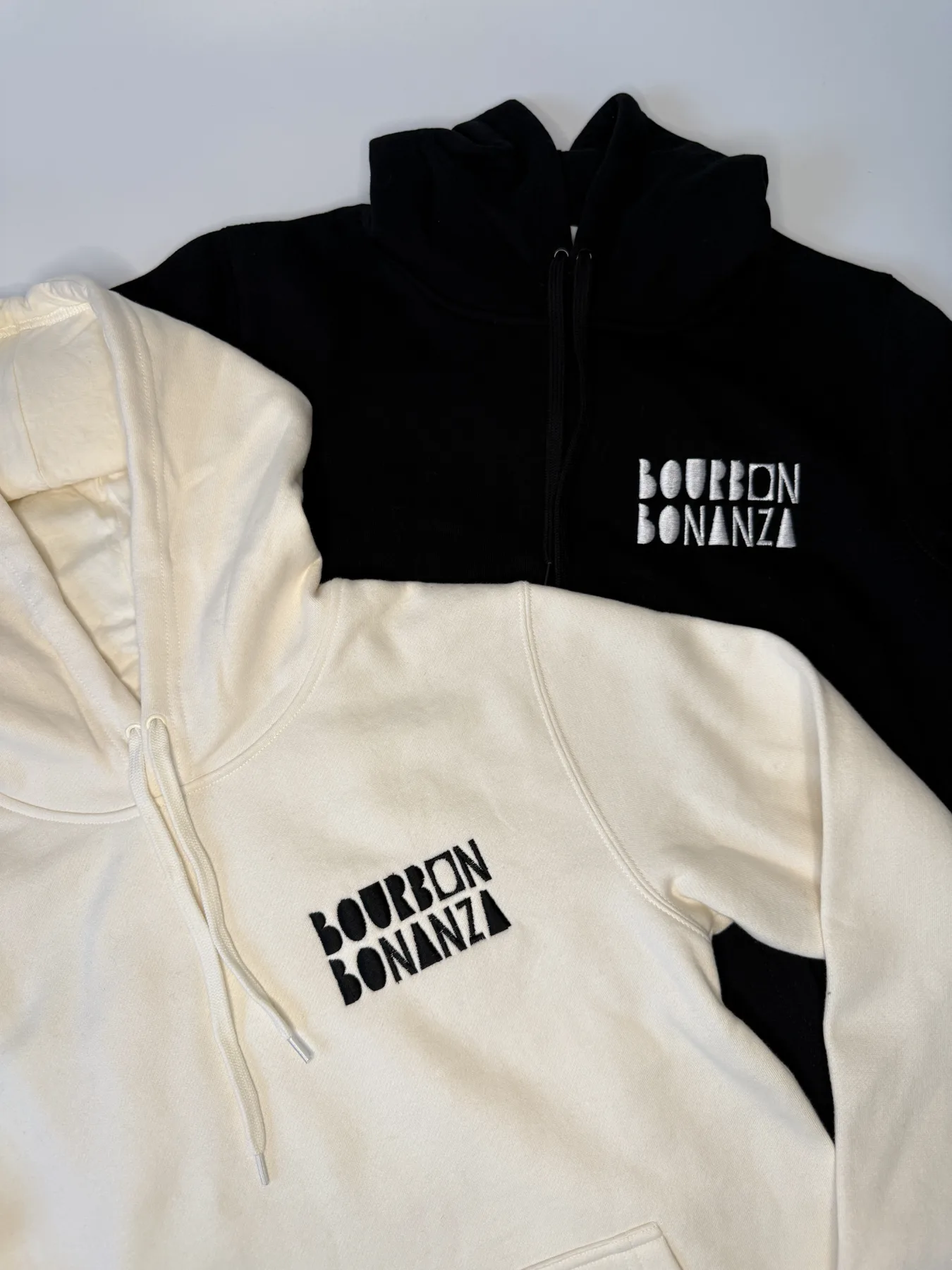 Black and cream Bourbon Bonanza zip-up hoodies